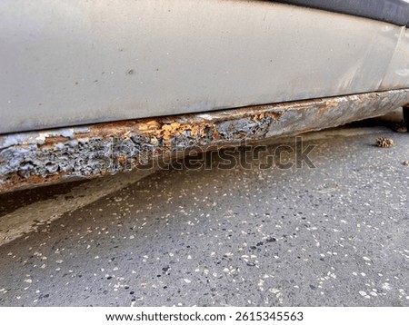 rusted and decayed car sill with visible corrosion and metal damage closeup detail of vehicle body deterioration concept of auto repair rust protection car maintenance industry. High quality photo