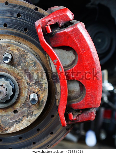 Rusted disc brake and\
caliper on car