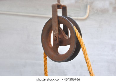 Rusted Iron pulley with jute rope used in wells for getting water.