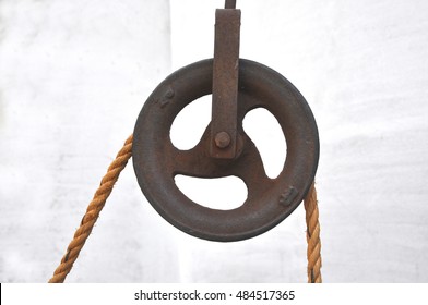 Rusted Iron pulley with jute rope used in wells for getting water.