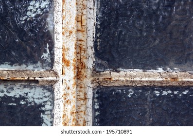 Rusted Neglected Window Frame With Flaking Putty