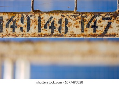 Rusted Numbers On The Hangers Of The Abandoned Swimming Pool Changing Room