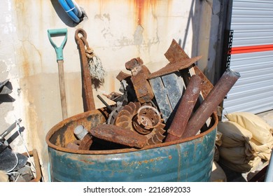 Rusted Old Boat Motor Parts In Blue Metal Trash Can