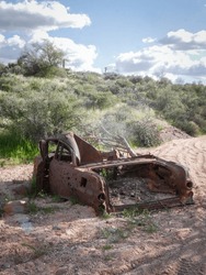 Rusted Old Car Abandoned In Sand Wash In Off Roading Area Near Phoenix Arizona