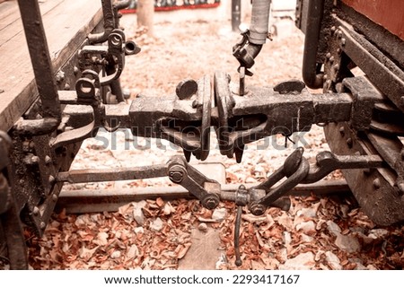 A rusted old Damper dashpot between two railways wagons. A link between two train cars Stock photo © 