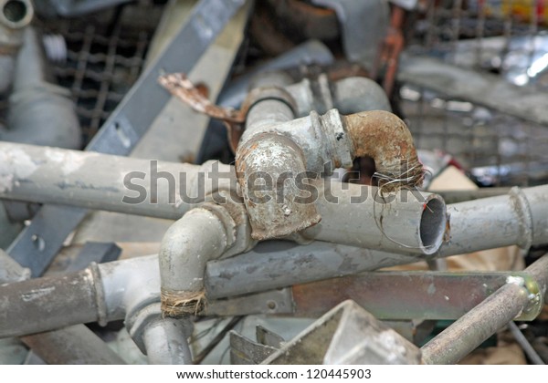 rusted and old iron pipes and lead into a\
junkyard of ferrous\
material