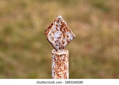 Rusted Old Vintage Retro Outdoor White Metal Fence Ornament On Top Of Strong Metal Pole In Family House Backyard On Cold Winter Day