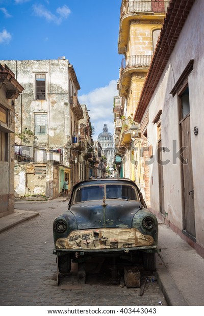 Rusted Old\
Wrecked Car On The Streets Of\
Havana