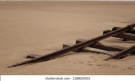 Rusted Rail Track Sinking Into Desert Sand