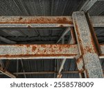 Rusted roof trusses. Rusted building construction. Rust texture that occurs on mild or galvanized steel frames