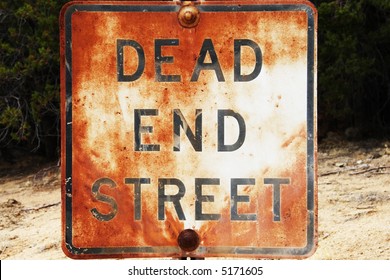 Rusted and weathered Dead End sign.