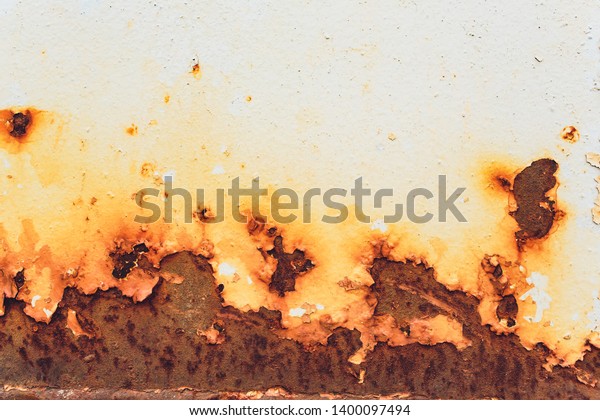 Rusted white painted metal wall.\
Rusty metal background with streaks of rust. Rust stains. The metal\
surface rusted spots.metal rust texture\
background.