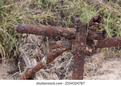 Rusted World War 2 era coastal defences at Gibraltar Point, Skegness, Lincolnshire.  Remains of anti-landing scaffolding, designed to hinder invasion by boat.  Detail of rusted metal.  October 2023. - Powered by Shutterstock