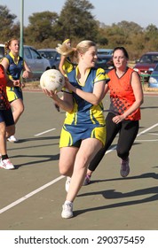 RUSTENBURG, SOUTH AFRICA - June 6:  Korfball League games played at Olympia Park on June 6, 2015 in Rustenburg South Africa.  Ladies team:  Girl trowing ball.