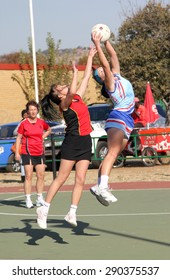 RUSTENBURG, SOUTH AFRICA - June 6:  Korfball League games played at Olympia Park on June 6, 2015 in Rustenburg South Africa.  Ladies team:  Girl catching ball.
