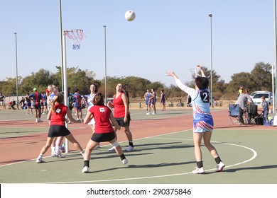 RUSTENBURG, SOUTH AFRICA - June 6:  Korfball League games played at Olympia Park on June 6, 2015 in Rustenburg South Africa.  Ladies team:  Girl goal trowing ball at net.