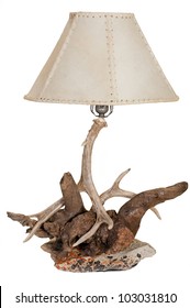 A Rustic Antler, Rock And Driftwood Lamp Isolated On White Background