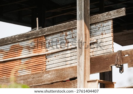 Rustic Assemblage composition of weathered timber and rusted corrugated zinc sheets, reflecting the raw charm of vernacular architecture and industrial aging in a rural setting.