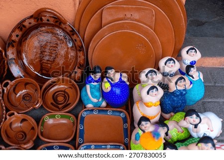 Rustic Assortment of Ceramic Dinnerware and Figurines Displayed for Sale