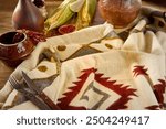 Rustic Autumn Table Setting with Corn, Spices, and Southwestern Blanket.