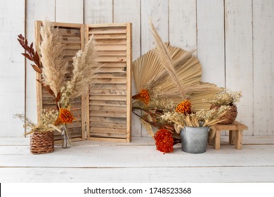 Rustic backdrop made with dried leaves and red little flowers. - Shutterstock ID 1748523368
