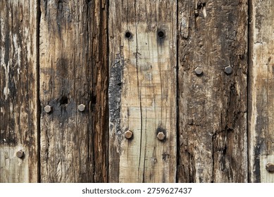 A rustic background featuring vertical weathered wood planks with visible grain, knots, and rusted bolts.