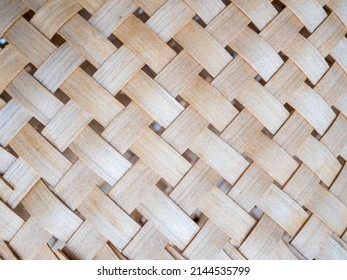 Rustic background from natural material. Texture of a wicker basket close-up. Straw weaving craft