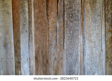 Rustic background texture of weathered vertical wooden planks with natural grain and nails
