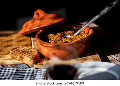 Rustic baked cabbage with meat served in traditional clay pot. Authentic homemade Serbian or Balkan winter food, comfort dish made with sauerkraut and pork