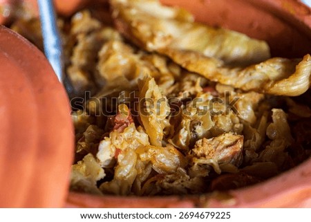 Rustic baked cabbage with meat served in traditional clay pot. Authentic homemade Serbian or Balkan winter food, comfort dish made with sauerkraut and pork