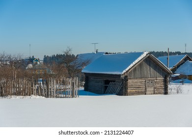 Rustic Barn With Snow On The Roof