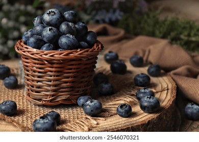 A rustic basket filled with fresh blueberries sits atop a wooden surface, creating a vibrant and natural display perfect for health-themed projects or culinary uses. - Powered by Shutterstock