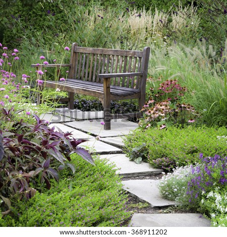 A rustic bench invites visitors to rest and enjoy the wonderful garden architecture of Cantigny Park in Wheaton, Illinois.