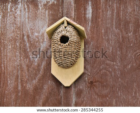 A Rustic Bird Box Made From Wood and Rope.