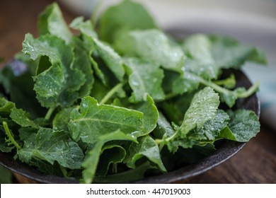 Rustic Bowl With Fresh Baby Kale Leaves, Overhead View