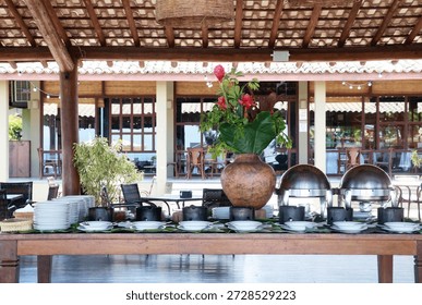 Rustic Brazilian feijoada buffet table set in an open-air restaurant.