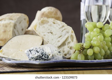 Rustic Bread And Cheese Platter With Grapes And Wine