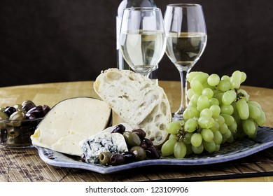 Rustic Bread And Cheese Platter With Grapes And Wine