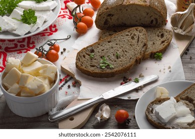 Rustic Bread with Feta, Parsley, and Cherry Tomatoes, Fresh Ingredients on Wooden Board. Feta-Topped Bread with Herbs and Tomatoes, Rustic Kitchen Setup. - Powered by Shutterstock