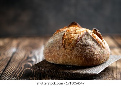 Rustic bread on a rustic background with copy space. - Shutterstock ID 1713054547