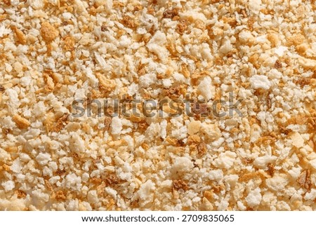 Rustic breadcrumbs on a white background, ideal for creating crunchy, homemade-style coatings and textured culinary preparations.