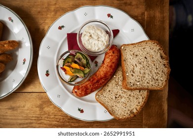 Rustic breakfast with sausage and bread - top view on wooden table                       