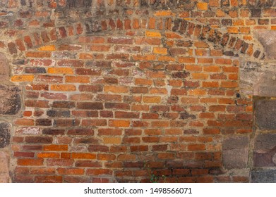 Rustic brick wall with ornamental arch in various sized cutouts as background