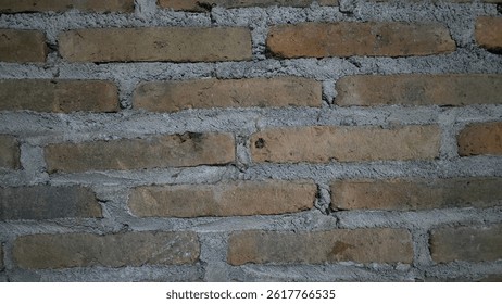 Rustic brick wall texture with visible mortar. Old construction material