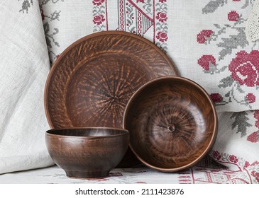 Rustic Ceramic Clay Cup On An Embroidered Tablecloth. 