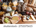A rustic cheese and bread spread featuring various cheeses, fresh grapes, passion fruit, and assorted breads on a wooden table, creating a cozy, artisanal vibe.