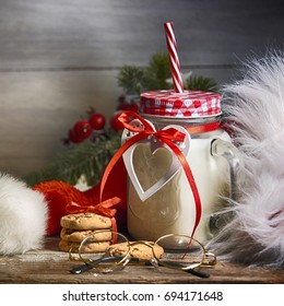 Rustic Christmas background with milk and cookies to Santa - Shutterstock ID 694171648