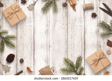 Rustic Christmas Composition On White Wooden Table. Top View, Flat Lay Scene With Copy Space In Middle