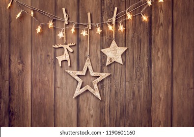 Rustic Christmas decorations and string lights on a wood style background