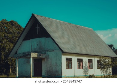 Rustic church with a metal roof under a clear sky in Yahukimo, Papua, Indonesia. - Powered by Shutterstock